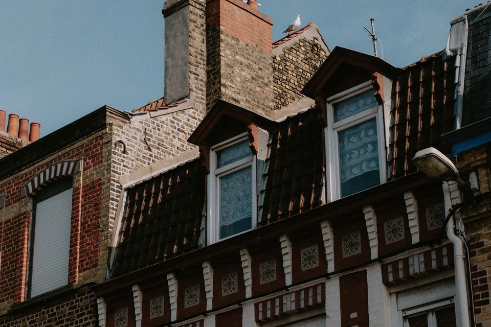 Crop of a brick rooftop with dormer windows, sharp original